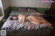 A woman laying on top of a bed in a bedroom.