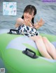 A woman sitting on top of an inflatable raft in the water.