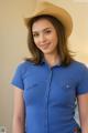 A woman in a blue shirt and a cowboy hat.