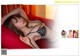A woman in lingerie laying on a red couch.