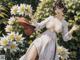 A woman in a white dress holding a bunch of flowers.